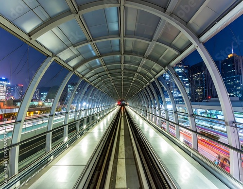 Modern high speed train in futuristic glass tunnel.
