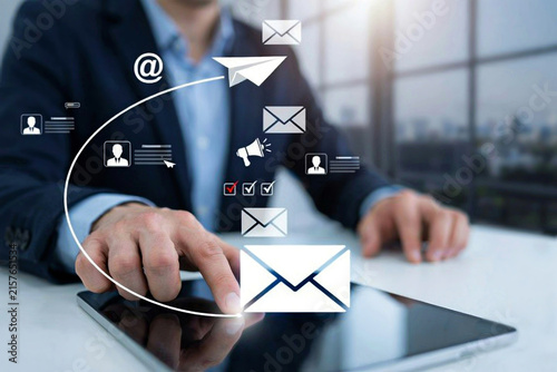 Businessman sending paper airplane email icon and digital newsletter campaign from tablet