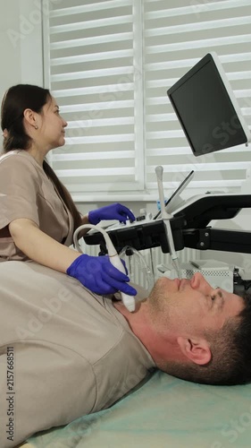 Ultrasound assessment provides clear visualization of thyroid anatomy. Doctor conducts early recognition of patient pathological changes vertical shot