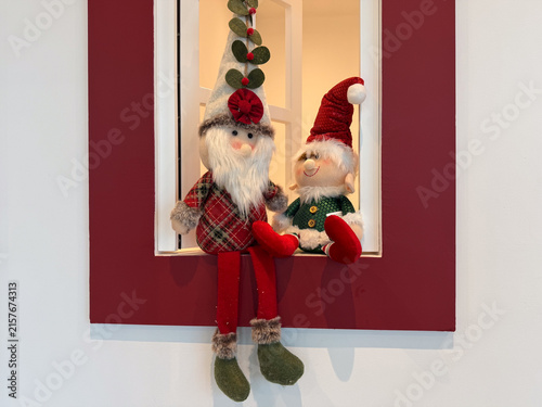 smiling christmas gnomes on red window sill, banner space, concept of holiday, retail