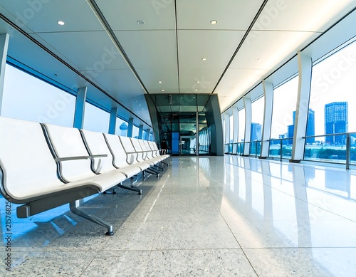 Modern airport terminal with jet bridges and seating area.