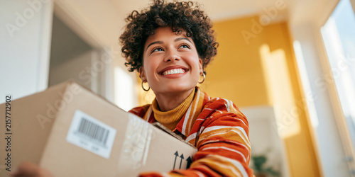 Smiling woman holding delivery box for e commerce