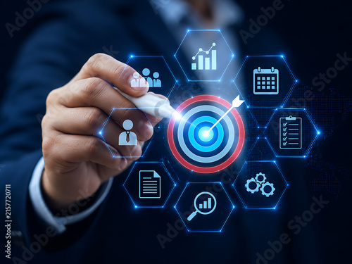 Business strategy concept with hand touching glowing icons representing data analysis and target achievement
