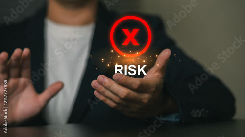 Businessman Displaying Risk Concept with Red Cross Icon and 