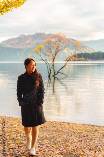Photography Woman Walking Along Lake Shore with Autumn Foliage and Mountain View in Wanaka N