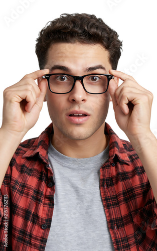 Young man wearing glasses and plaid shirt looks surprised or confused studio portrait surprised confused clothing