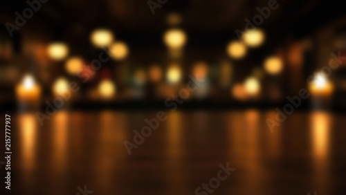 Empty dark walnut wooden table surface with blurred warm restaurant bar interior bokeh background for product display mockup and food photography presentation