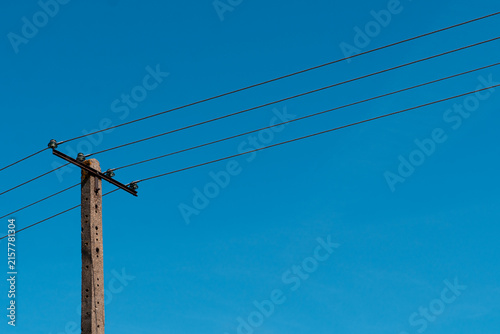 Bild auf Leinwand Electrical power pole and overhead power lines against clear blue sky, energy in