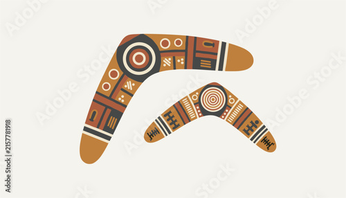 Pair of traditional Australian boomerangs decorated with colorful indigenous folk art patterns on a light background.
