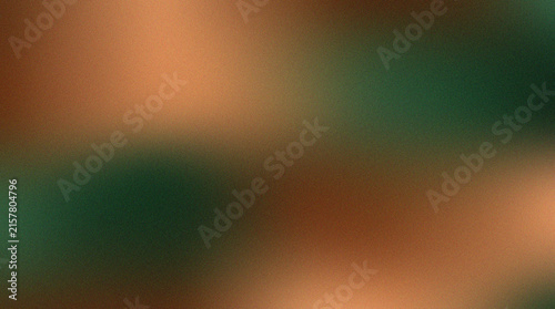 Abstract blurred gradient background with grainy texture and soft green and copper tones.