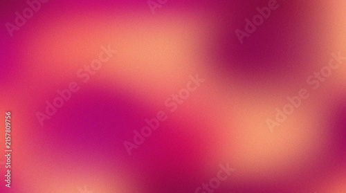 Abstract grainy gradient background with soft pink and orange blurred color transitions.