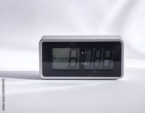 Naklejka Silver rectangular digital desk clock showing eight o'clock.