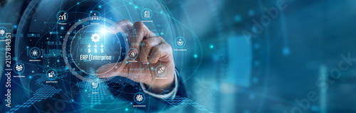 A systems analyst handhold ERP (Enterprise Resource Planning) tools. Specialist using platforms tracking corporate logistics and financial workflows on a laptop. Unified business operations.