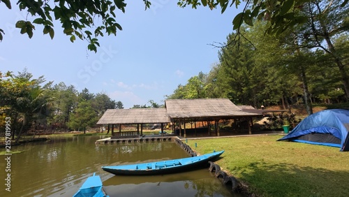 Cuadro en lienzo Scenic view of a traditional rowboat tied to a wooden dock on a beautiful lake