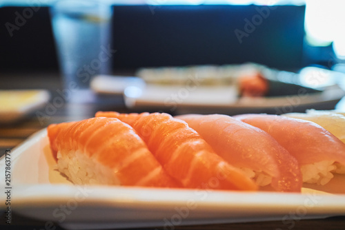 Close-up of salmon nigiri with rice visible underneath