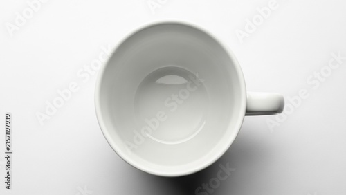 Top down view of a clean empty white ceramic coffee cup