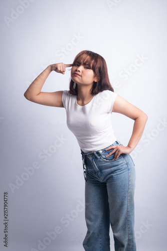 Playful confident woman in white t-shirt and jeans