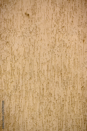 Фотография Unique texture of aged plaster wall with vertical lines and markings during gold