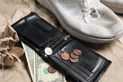 Photography Old sneaker, wallet and money on kraft paper, closeup
