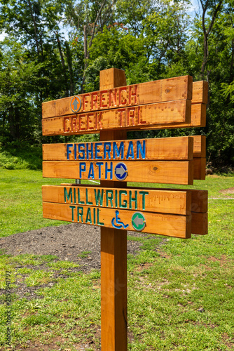Obraz na płótnie Wooden directional trail sign for French Creek Trail, Fisherman Path and Millwright Trail near historic Snyder's Mill in Phoenixville, Pennsylvania