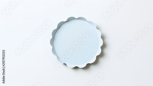 Minimalist blank scalloped-edge round coaster in soft sage green, isolated on a clean white background with a subtle shadow, ideal for product mockups, label design, packaging, and copy space layouts.