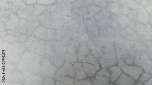 Cracked concrete wall texture background with fine hairline cracks pattern