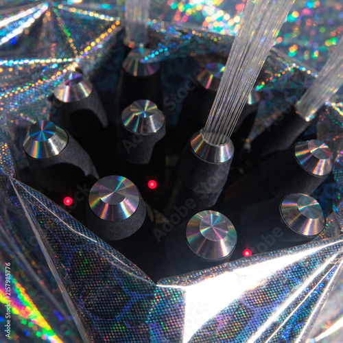 A close-up of a high-speed fiber-optic junction box wrapped in a shimmering, protective holographic security shield.  