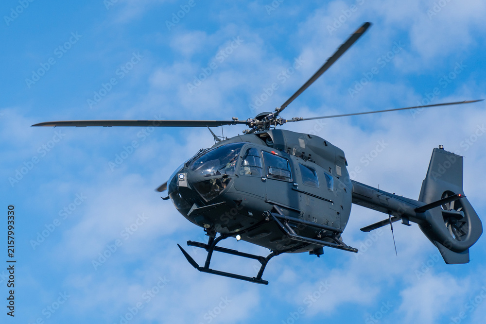 Fototapeta premium Black modern military transport helicopter flying over Budapest, Hungary