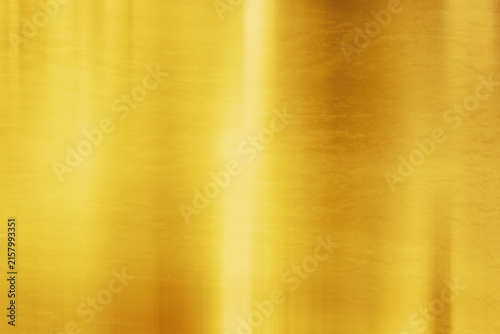 Golden metallic texture background with soft vertical reflections

