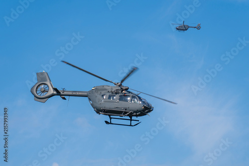 Black modern military transport helicopter flying over Budapest, Hungary