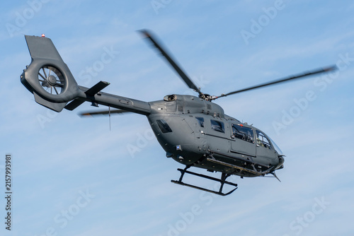Black modern military transport helicopter flying over Budapest, Hungary