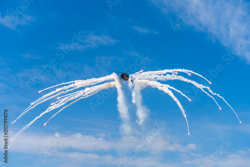 Black modern military transport helicopter shrouded in smoke over Budapest