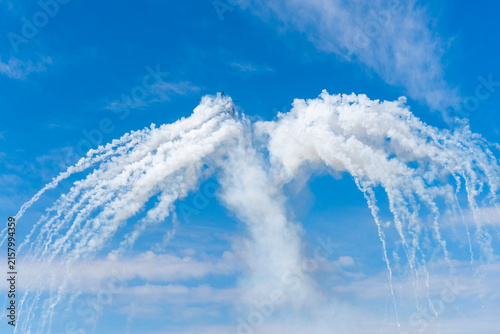 Black modern military transport helicopter shrouded in smoke over Budapest