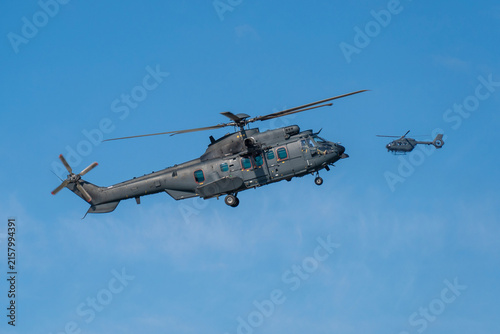 Black modern military transport helicopter flying over Budapest, Hungary