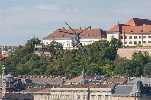 Black modern military transport helicopter flying over Budapest, Hungary