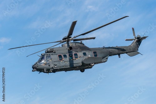 Black modern military transport helicopter flying over Budapest, Hungary