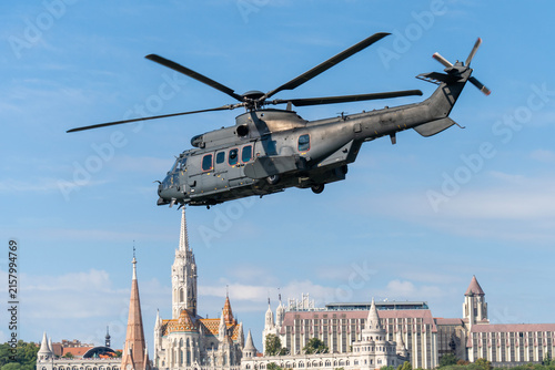 Black modern military transport helicopter flying over Budapest, Hungary