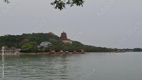 Ancient Chinese pagoda stands on Longevity Hill by Kunming Lake outdoors. Asian tourism, historical landmarks, summer palace Beijing.