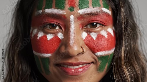 Close-up Portrait of a Young Woman with Vibrant Face Paint Inspired by Cultural Traditions, Smiling
