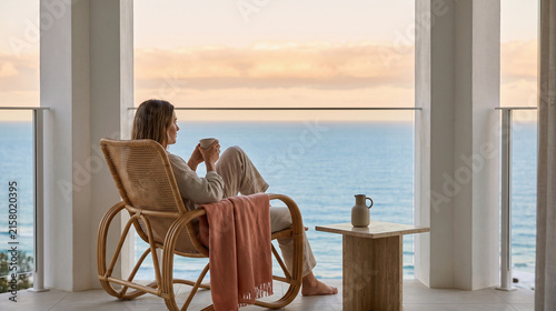 Serene coffee pause on a seaside balcony above the clouds