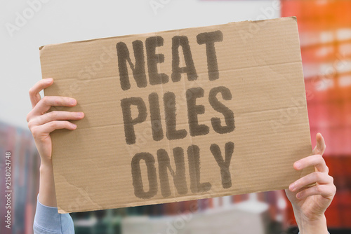 Fotografie "Neat Piles Only" The officer's bored monotone dictates order