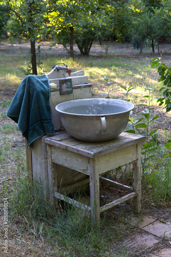 Принти на полотні Rustic outdoor wash basin and old wooden washstand in a country garden