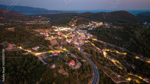 Aerial view of road and mountain village at dusk