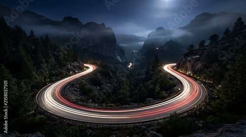 Curving mountain road with light trails at night showcasing motion blur