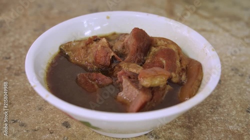 Traditional Malaysian-style bak kut teh featuring tender pork ribs and meat simmered in a rich, dark herbal broth.