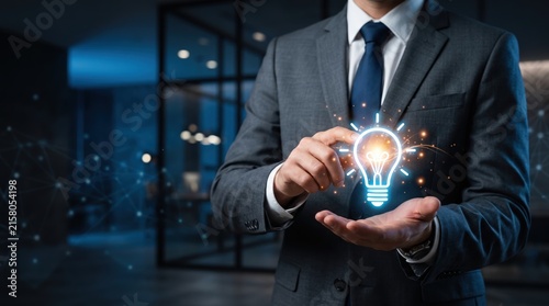 Businessman holding glowing light bulb hologram symbolizing innovation idea and creative solution for startup company, digital transformation with futuristic network technology.