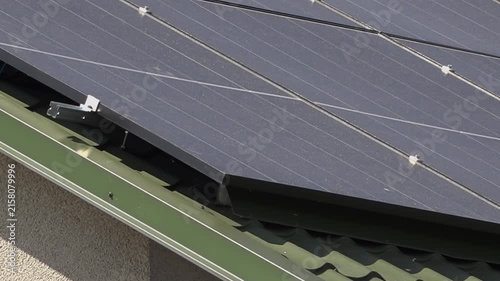 Solar panels installed on the roof of a city building. Concept of eco friendly and alternative power source. 