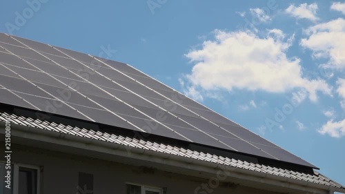 Solar panels installed on the roof of a city building. Concept of eco friendly and alternative power source. 