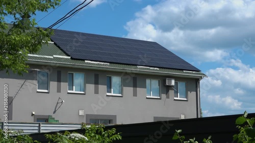 Solar panels installed on the roof of a city building. Concept of eco friendly and alternative power source. 