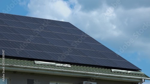 Solar panels installed on the roof of a city building. Concept of eco friendly and alternative power source. 